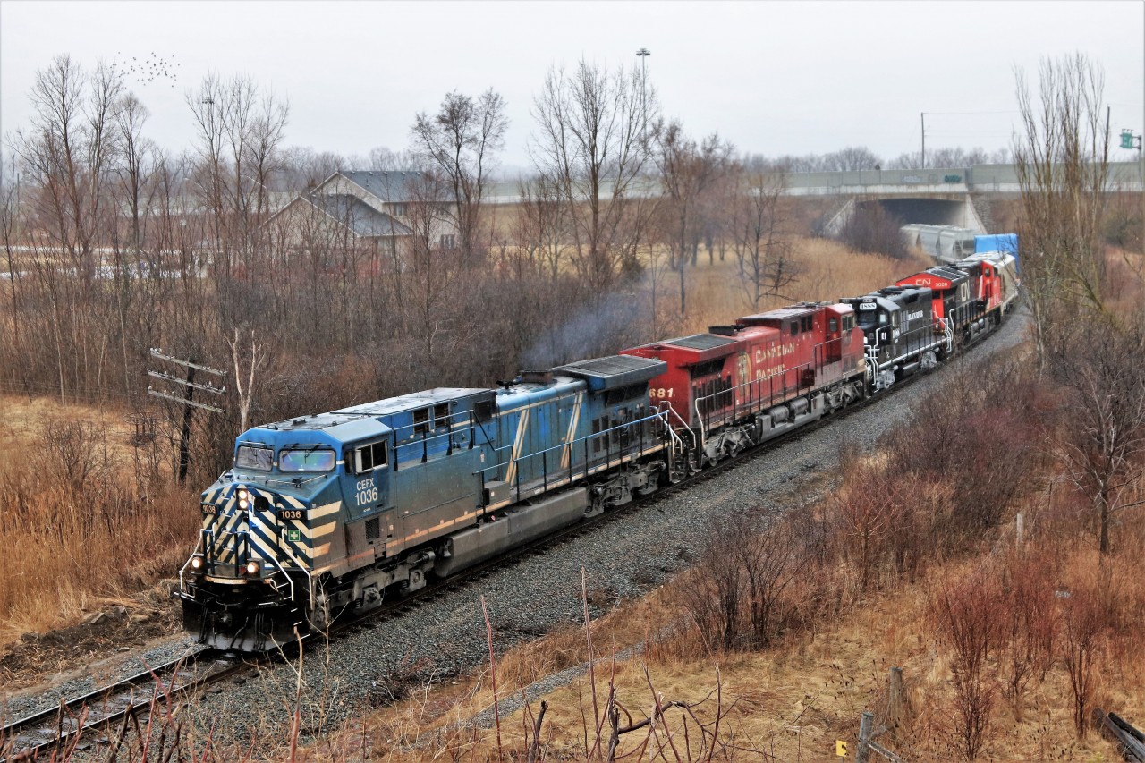 Its not often you find a quartet of power with four different lines. Here CEFX 1036 leads CP 9681, BDRV 1888 and CN 3026 out from under Highway 6 bridge approaching Newman Road on the Hamilton sub. The BDRV 1888 is on its way to the Black River and Western Railway in New Jersey. As is normally the case, the best trains come in the rain and with a light fog.