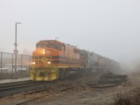 GEXR 3030 with GEXR 3054 and GEXR 3394 work their way through the light rain and fog as they head through the Acton Go station.