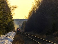 With the sun setting for another day, eastbound train 406 passes mile 5 of the CN Sussex Sub, as they begin the uphill climb to Fundy, and arrive at their final destination of CN's Gordon Yard in Moncton, New Brunswick. 