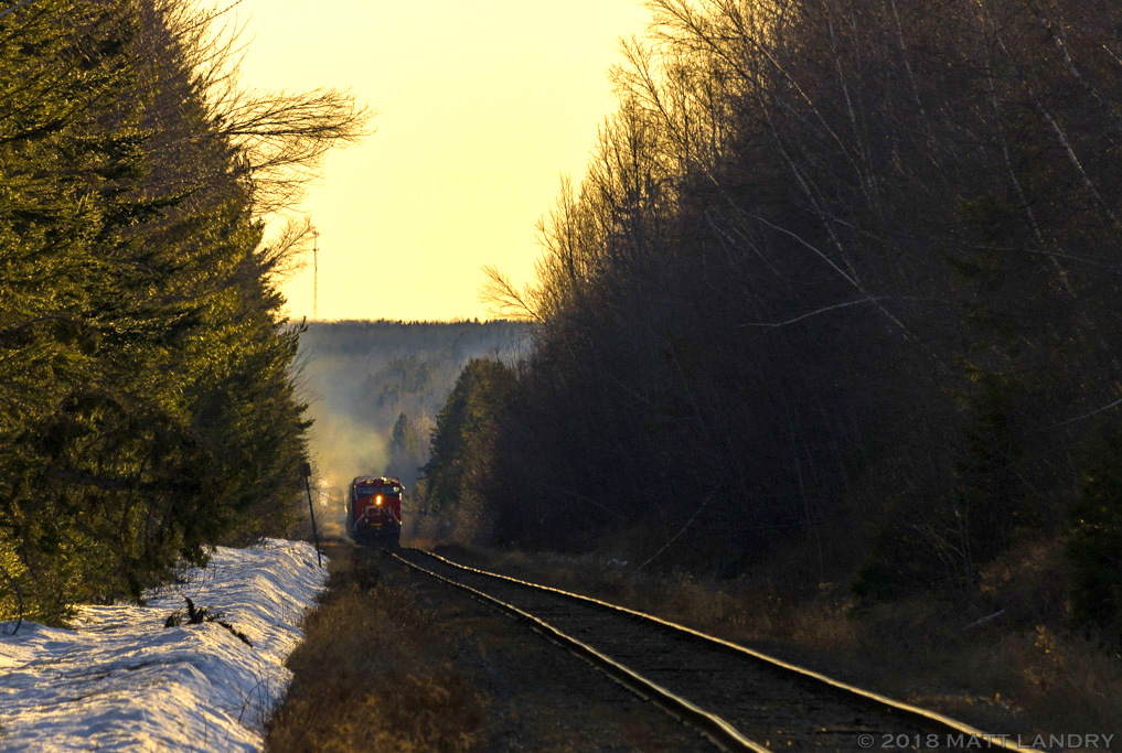 With the sun setting for another day, eastbound train 406 passes mile 5 of the CN Sussex Sub, as they begin the uphill climb to Fundy, and arrive at their final destination of CN's Gordon Yard in Moncton, New Brunswick.