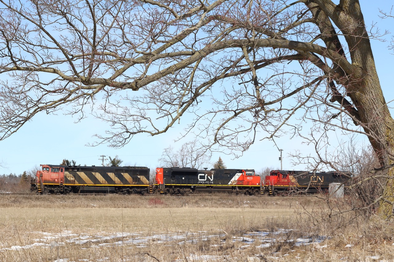 The temperature is finally reading double digits as we near the end of April. The last of the snow has yet to melt as CN train 435 rolls through the dormant scenery at Stewartown just west of Georgetown.