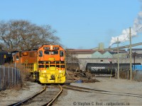 While I usually remark that I spend a lot of time here, one must not remiss the Men and Women who work this line day in and out.. they spend far more time down here then I do, I just tote my big camera every once in a while..<br><br>
And this is the kind of scene I love to shoot, gritty Hamilton, Dofasco smokestacks, tank cars..  holding tanks for Ruetgers Canada (formerly VFT) at right, and the Orange of G&W looks really really good here. Too bad 2117 has already gone tits up only a month after coming online - let's hope it's rebuilt quickly. 


