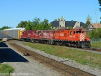 Here's the second shot <a href=http://www.railpictures.ca/?attachment_id=31301 target=_blank> from the first of a series at Galt Station </a> that shows three distinct paint schemes on three CP GP9's in their twilight of service. I love seeing photos from guys like James Adeney, Robert Farkas, Arnold Mooney and others who captured CP's twilight of service for various motive power eras - such as the end of the 1st generation ALCO's in the mid 70's or the end of the MLW era in mid to late 1990's. To me this photo captures some of this era-ending essence, the ratty mismatched paint schemes, locomotives that failed to be brought into the new corporate branding, paired with some that succeeded. <br><br>Bottom line is all of these are now gone, permanently off the CP roster. 8249 survives for now - sold to J&L Consulting, and the other two? I have no idea, but CP won't roster a GP9 ever again. CN still has plenty (for now) so young kids who missed CP's era can still get some on CN - don't waste time though - I would have called you out in early 2010's if you said by 2014 all CP GP9's will be off the roster - it happened fast. (Thanks, EHH).<br><br> Photo notes: Shot with my Nikon D800 in glorious 36 megapixel ultra high definition detail, at 70mm. Trust me when I say this, but if you zoom in on my shot the level of detail is phenomenal.  And I stood on my SUV's roof to get over those tall late summer weeds, and the elevation gives a little different perspective.