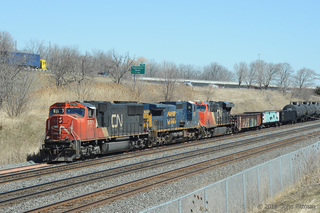 CN 5785 (SD75i), GECX 7315 (C40-8W ex-CSX same unit), and CN 2932 (ES44dc) leading train CN 421 have traversed Aldershot yard from east to west, dropping off part of their train and lifting other cars. They have stopped on the west yard lead, awaiting readiness to rejoin the Oakville sub at CN Snake to proceed to their activities at Hamilton's Stuart Street yard, after which they will continue the journey to Port Robinson.

This location required a hike through long grass and brush. In the warmer seasons we are well-advised to take precautions in similar terrain against the increasing risk of black legged ticks, vectors for Lyme disease etc.