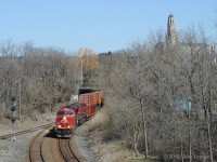 CP 8958 and CP 8815 are leading mixed freight train 246 south on the former TH&B under Main Street and into the curve toward the Dundurn Street bridge and Hunter Street tunnel. This is the main line side of the Aberdeen wye. Next stop is Kinnear Yard. <br>
In the background is Hamilton's RC Cathedral Basilica of Christ the King, completed in 1933. Access to the cathedral campus is by two driveways that cross this same railway line on bridges.
