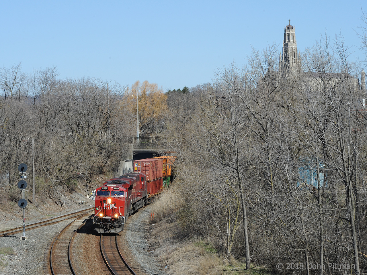 CP 8958 and CP 8815 are leading mixed freight train 246 south on the former TH&B under Main Street and into the curve toward the Dundurn Street bridge and Hunter Street tunnel. This is the main line side of the Aberdeen wye. Next stop is Kinnear Yard. 
In the background is Hamilton's RC Cathedral Basilica of Christ the King, completed in 1933. Access to the cathedral campus is by two driveways that cross this same railway line on bridges.