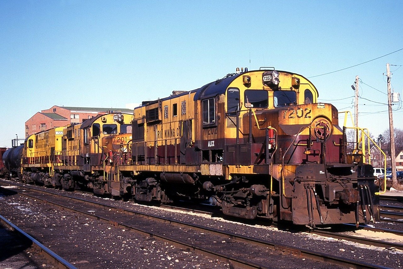 Three ex. Erie Mining Alcos from Hoyt Lakes, MN take a break in CP's Kinnear Yard before continuing on their journey to their new homes in New Jersey.  The CP crew coming on duty that would lift these units was nice enough to escort us to the sunny side of the units for a shot.  The home-shop chop noses on the two RS11s sure aren't pretty; considering they spent their career deep in the ore mine visual aesthetics clearly wasn't a concern.  The trailing C420 looked much better.

Someone had big plans for these units but in fifteen years no progress has been made.  Unfortunately C420 7221 ended up in Winslow Jct., NJ where it was heavily vandalised over the years and eventually scrapped.  RS11s 7201 and 7202 are currently stored on a siding in Dividing Creek, NJ on the Winchester and Western Railroad.  The siding also includes three former Long Island Railroad "Power Packs" rebuilt from FA1s, two former BC Rail Remote Control Cars (RCC) rebuilt from FBs and one ex. VIA FPB4.  My hunch is the Erie Mining Alcos were purchased for their "guts" to be transplanted in the Alco FA/FB units, but nothing has come to fruition.
