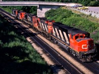 CN 9531 is part of a power move passing under the pedestrian bridge just north of Bayview Junction on July 24, 1980.