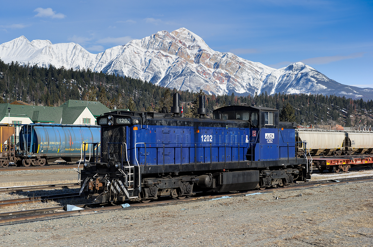 If you didn't guess, JLCX GMD1m 1202 is lost! It's seen sitting quietly on the shop track at Jasper waiting to hitch a ride back towards Edmonton on CN's train A412 shortly after this photo was taken. The unit was last in use recently in Shaver, AB (just south of Grande Prairie) at the large Weyerhauser Pulp and Paper facility. Since then, it's taken a trip south to Swan Landing, east to Edmonton, west to Jasper and is now hoping to go back east to its new home in Fort Saskatchewan, northeast of Edmonton. JLCX 1202 is ex SRY 1202, ex CN 1153 and nee CN 1053.