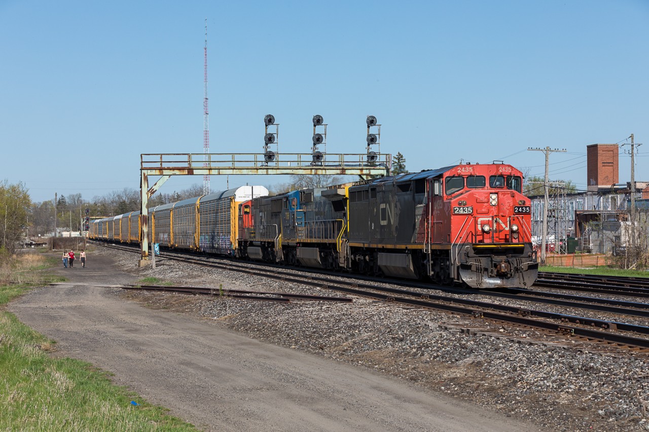 The weather is getting warmer, the days are filled with sunshine and it feels like spring has finally arrived in Southern Ontario! While the trees start to bloom and flowers blossom, CN has really been providing some colour of their own. Here, CN train no. 435 cruises through Paris with a grab-bag consist while some locals head towards the fishing ponds on a lovely May afternoon.