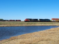 CN 105 is seen holding the main east of the siding at Neola. It is one of four trains stopped in the area as Biggar experiences some good old gridlock. In the background CP 8709 east fly's by at track speed, but it is about to encounter significant delays of it's own. 