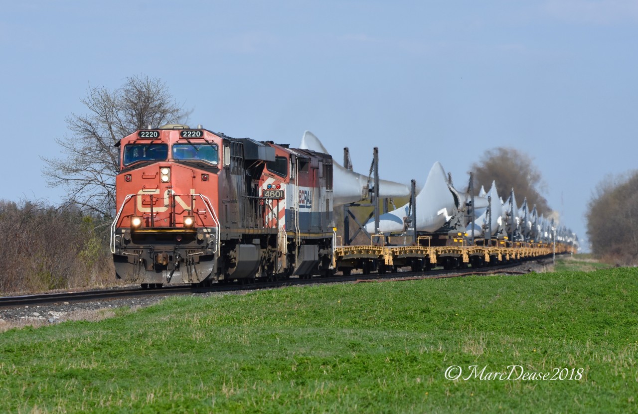 CN 2220 with a reasonably clean BCOL 4601 trailing lead a train load of blades past Camlachie Sideroad.