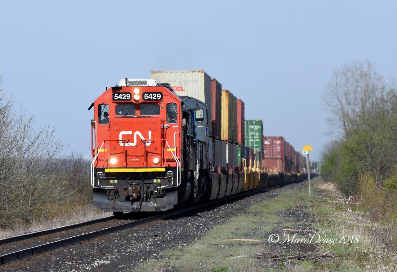 Early morning sun this time of gives the rare chance to photograph from the north side of Waterworks Sideroad. Train 148 with CN 5429 and IC 2466 head east bound out of Sarnia.