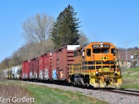 With twenty cars in tow QG 3102 rounds the curve at Pointe-au-Chene, Quebec.