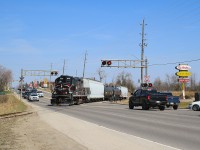 CCGX 4015 slowly crosses Broadway with four cars in tow prior to backing down a spur to service the PolyOne facility.