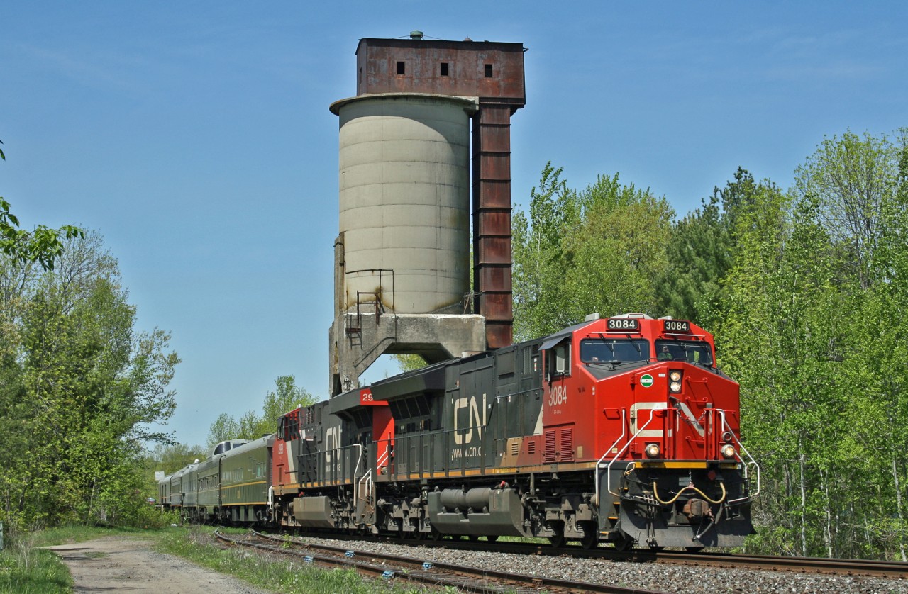 One of the few remaining coal towers from the steam era, makes for the perfect backdrop as a CN Passenger train with Green and Gold coaches rolls through Washago.  Train P 60251 21 operated from Edmonton to Moncton, moving 5 business cars into position for an event in the Maritimes.  

Consist was:
CN 3084
CN 2998
IC 800653 (Sanford Fleming)
CN 99 (American Spirit)
IC 800210 (Baton Rouge)
IC 101314 (Champlain)
CN 1710 (Fraser Spirit)