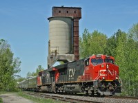 One of the few remaining coal towers from the steam era, makes for the perfect backdrop as a CN Passenger train with Green and Gold coaches rolls through Washago.  Train P 60251 21 operated from Edmonton to Moncton, moving 5 business cars into position for an event in the Maritimes.  

Consist was:
CN 3084
CN 2998
IC 800653 (Sanford Fleming)
CN 99 (American Spirit)
IC 800210 (Baton Rouge)
IC 101314 (Champlain)
CN 1710 (Fraser Spirit)

