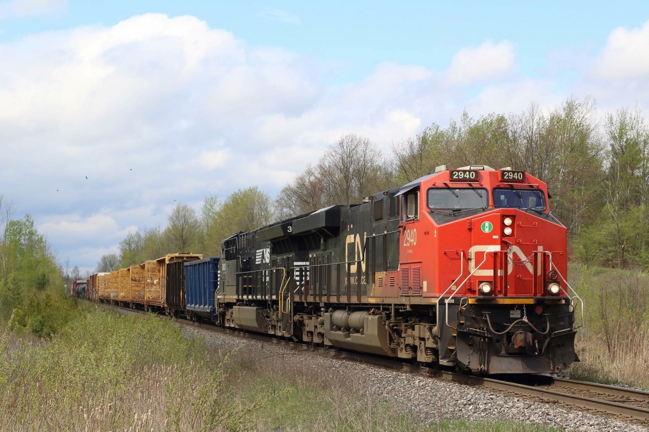 Turkey vultures soar high above as CN train 383 coasts downgrade at mile 30 of the Halton Subdivision. Norfolk Southern GE built Tier 4 #3623 trails the lead GEVO. A cut of empty CSX coal hoppers were mid train returning from a plant in Quebec.