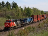 CN 3801 from what I’ve been told was a credit unit from GE, eventhough it was delivered after the Tier 4 production began. Here we see it was CEFX 1024, which definitely spent some time previously on CP before being returned. The pair are seen dragging train 148 up the grade at Mile 30 as they travel through Halton Hills on their way to BIT intermodal terminal in Bramalea.