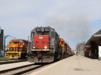The throaty cry of a trio of second generation END’s echoes off the turn of the century Krug furniture factory across the tracks from the shared VIA / GO station at Kitchener, as GEXR Road train excelerates out of town after a tail end drop at the yard. Lead unit “tunnel motor” #3054 is a fan favourite and probably one of the most phographed locomotives in Ontario, that isn’t an Alco, or “F” unit. By years end not only the locomotives here will change but the paint scheme too as CN ends the lease of the line to the GEXR. The sight of second generation road units here surly will fade as newer wide cab, more environmentally friendly motive power takes over. Luckily the locals should still see a mix of older GP38s and GP9 rebuilds for years to come. Thanks Goderich Exeter for the fond memories, you will be missed, but at least the shortline should still survive on the lines to Goderich as well as to Hensal.