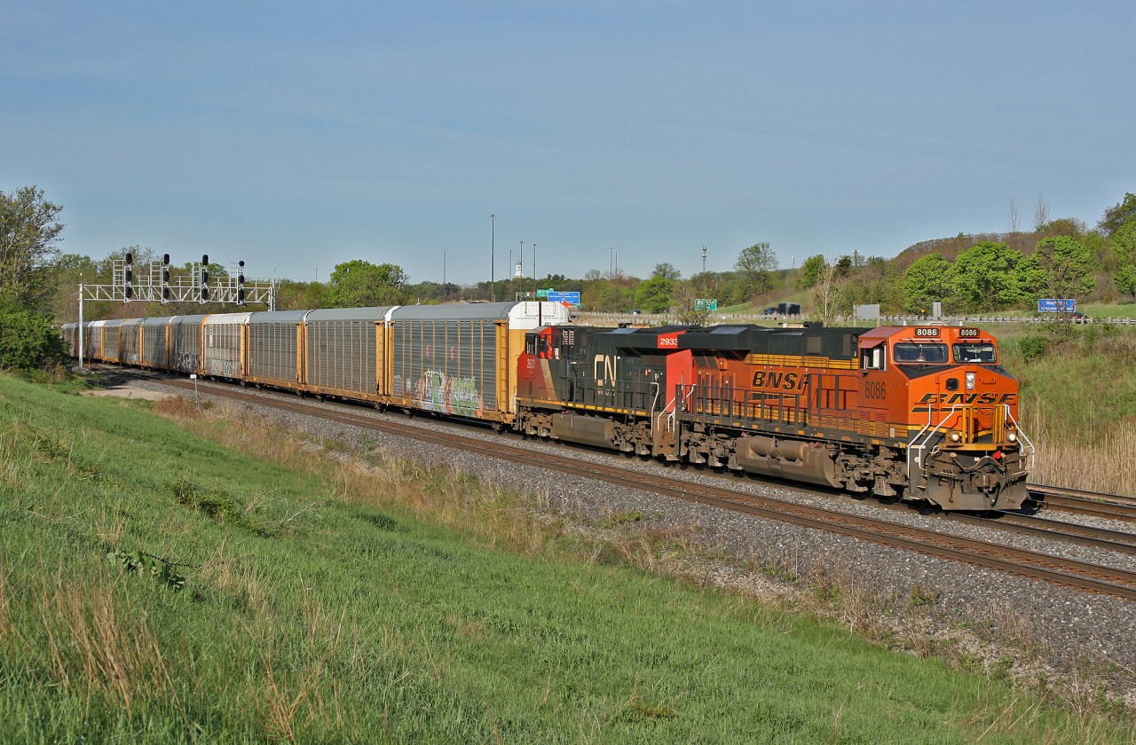 BNSF 8086 and CN 2933 drag a 147 car M 38461 20 through the plant at Snake on a beautiful spring morning.