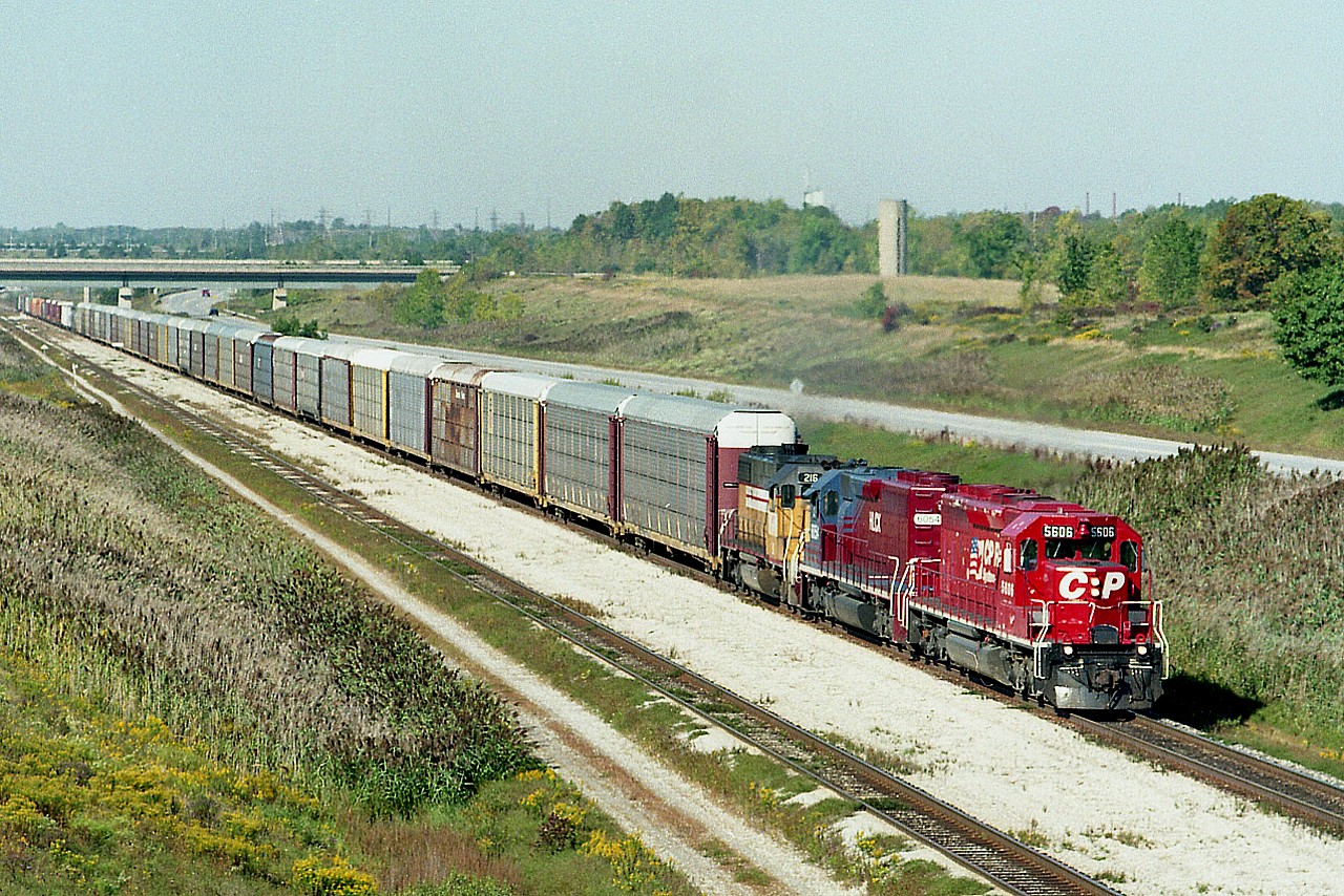 Back in those heady days of continuous leasing by the major roads; a typical CP train shown here Buffalo-bound has a pair behind the leader. Consist is CP 5606, HLCX 6054 and HATX 216. The train has just exited the Welland canal tunnel, running eastward. I am shooting from the overhead CN Stamford Sub bridge on a beautiful fall day.