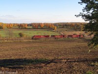 An eastbound Canadian Pacific ethanol train with three big GE's up front passes by the farmer's fields and fall colours at Lens, Mile 61.7 of CP's Belleville Sub.