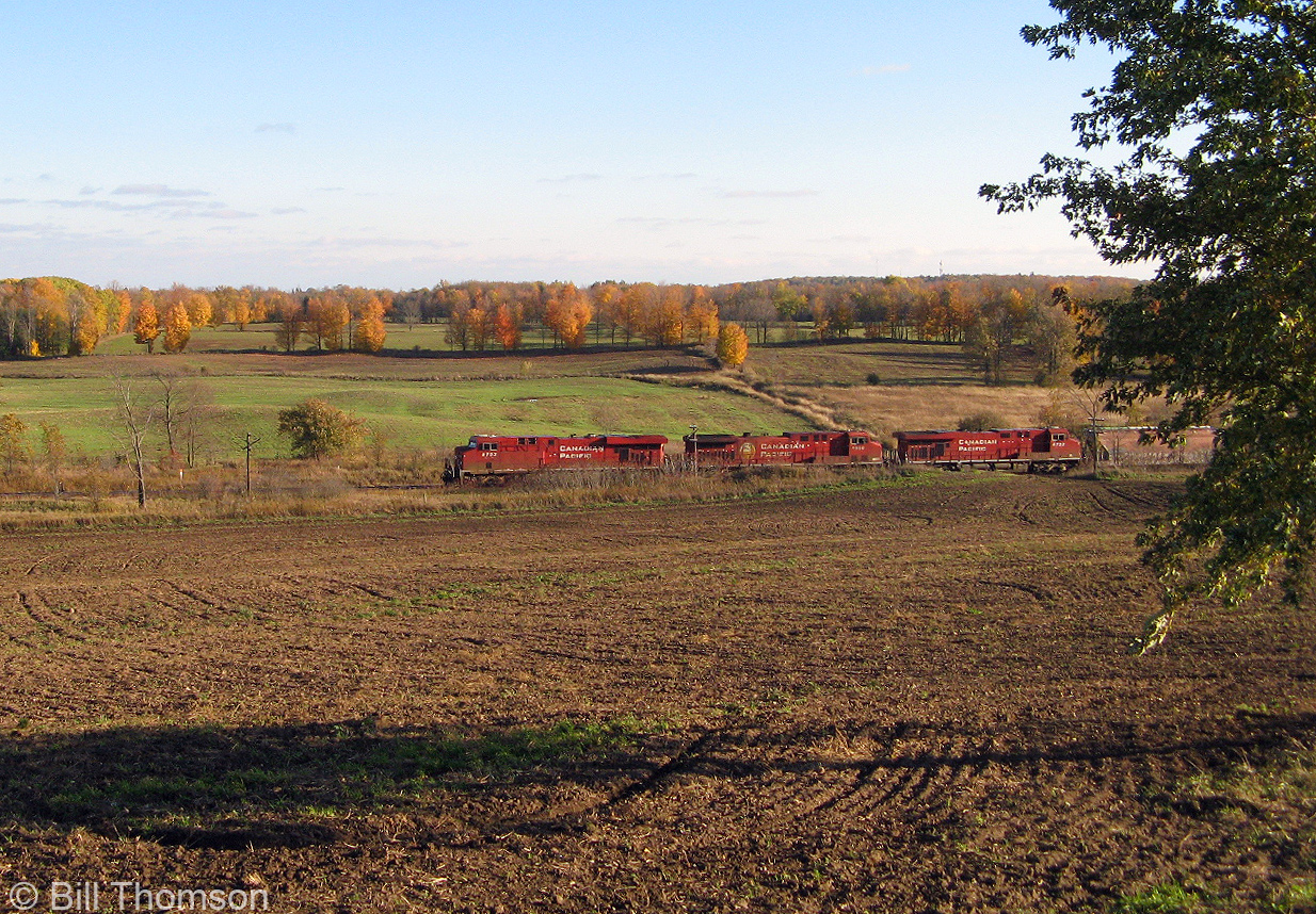 An eastbound Canadian Pacific ethanol train with three big GE's up front passes by the farmer's fields and fall colours at Lens, Mile 61.7 of CP's Belleville Sub.