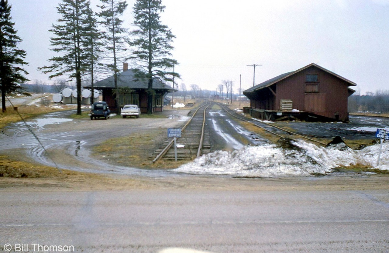 Canadian Pacific's Mount Forest station (left) and freight sheds (right, used by a local co-op) are pictured at the dead-end of CP's Mount Forest Spur, a short 1.2 mile line branching north from the Mount Forest Wye at MP 33.1 CP Teeswater Sub. Visible on the far right is an interchange/transfer track that ran for 0.2 miles to connect with CN's Owen Sound Sub at Mile 26. In the distance, another siding stopping short of the station was used for the stock pens. There were also engine servicing facilities here in the steam era, including a roundhouse and turntable.

The short Mount Forest Spur was originally built by the Toronto Grey & Bruce Railway in the early 1870's intending to run all the way to Owen Sound, but due to a lack of a subsidy from the county an alternate line was built to Owen Sound instead (the Owen Sound Sub from Orangeville to Owen Sound). The line to Mount Forest remained a short stub, and the Teeswater Sub from which it branched off ran through mostly rural countryside, suffering from low and declining traffic over the years until the line and its spurs were eventually abandoned in early 1988.