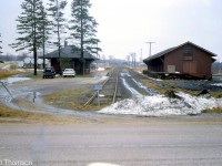 Canadian Pacific's Mount Forest station (left) and freight sheds (right, used by a local co-op) are pictured at the dead-end of CP's Mount Forest Spur, a short 1.2 mile line branching north from the Mount Forest Wye at MP 33.1 CP Teeswater Sub. Visible on the far right is an interchange/transfer track that ran for 0.2 miles to connect with CN's Owen Sound Sub at Mile 26. In the distance, another siding stopping short of the station was used for the stock pens. There were also engine servicing facilities here in the steam era, including a roundhouse and turntable.
<br><br>
The short Mount Forest Spur was originally built by the Toronto Grey & Bruce Railway in the early 1870's intending to run all the way to Owen Sound, but due to a lack of a subsidy from the county an alternate line was built to Owen Sound instead (the Owen Sound Sub from Orangeville to Owen Sound). The line to Mount Forest remained a short stub, and the Teeswater Sub from which it branched off ran through mostly rural countryside, suffering from low and declining traffic over the years until the line and its spurs were eventually abandoned in early 1988.