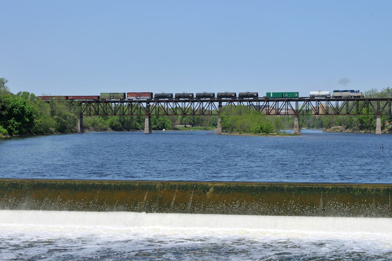Delaware & Hudson GP38-2 7303 leads the weed sprayer train Eastbound across the Grand River at a blistering pace of 10MPH