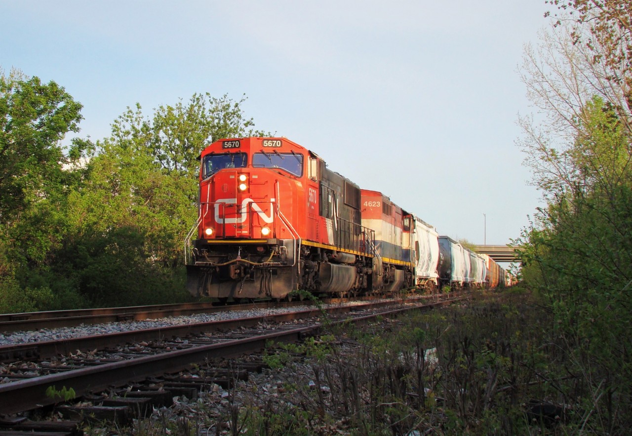 CN 5670 and BCOL 4623 lead a 50 car 438 under the E.C. Row Expy and out of Windsor as they head up the Pelton spur, former C&O Sub. 1 at Walkerville Jct.