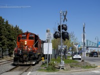 A transfer led by CN 7226 is sitting at the western end of Port of Montreal trackage, where it becomes the CN Wharf Spur. It cannot leave until security is in place to flag the many crossings in this area, but soon new crossing gates (an unfinished one is seen here) will render the flagging unnecessary.