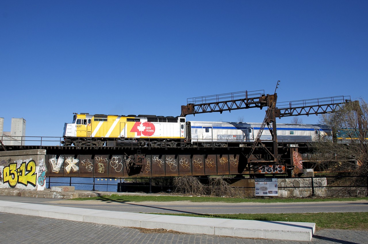 Wrapped VIA 6437 leads VIA 64 over the Lachine Canal five minutes before it reaches its terminus of Central Station in Montreal.