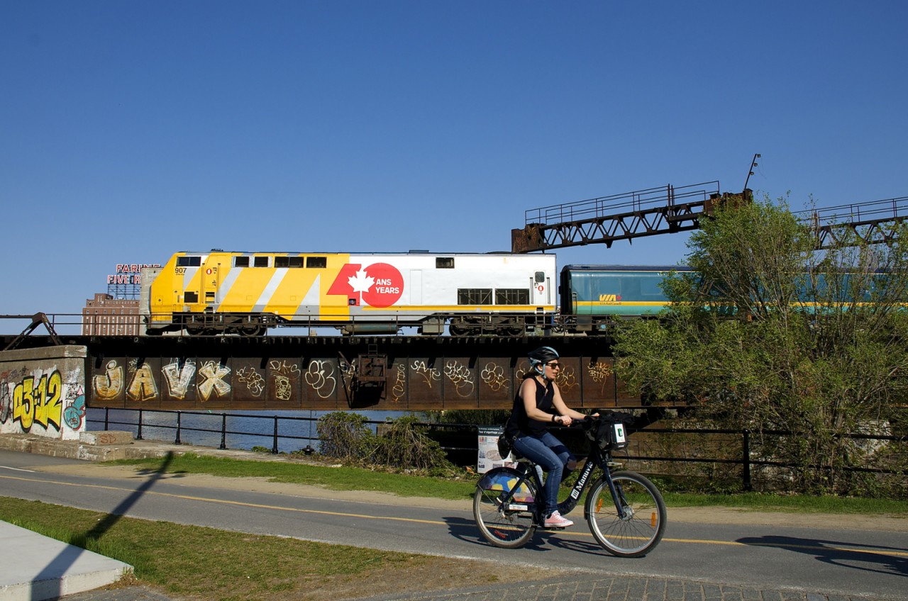 VIA 907 pushes VIA 37 over the Lachine Canal bike path and the canal itself. After changing directions it will head towards its terminus of Fallowfield, Ontario.