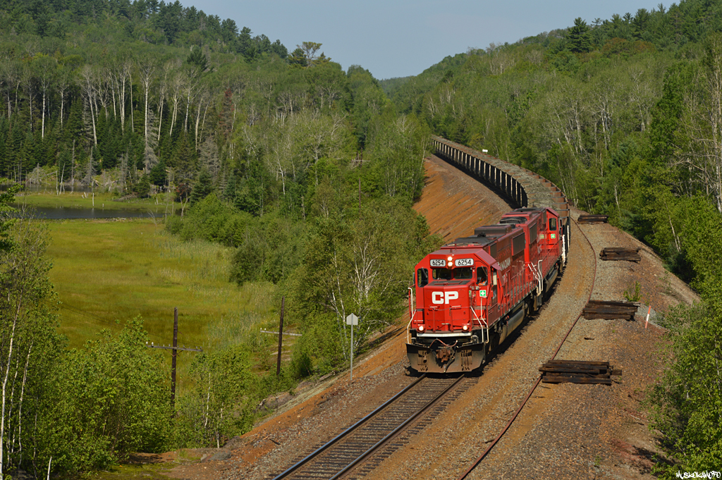 CP 6254 East with U55 seen just East of Levack after running around their train, headed to Sprecher with loads for Vale on a beautiful September morning.