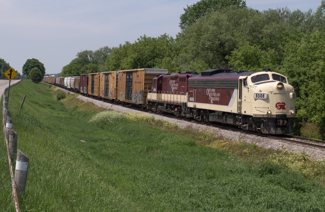 A pair of classy looking OSR units lead the Woodstock Job as they approach the diamond with CN at Carew.