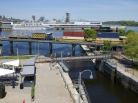 Intermodal train CN 148 derailed on CN's Wharf Spur early this morning and the cleanup continued throughout the day today. Here Port of Montreal power (POM 2007 & POM 1002) is about to pull a short cut of 7 or 8 platforms into the Port of Montreal. It is not very common to see Port of Montreal power on this trackage.