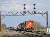 CN X321 with a pair of ES44AC's slowly approaches Coteau Yard where he will lift more cars. He is passing under a classic signal bridge just past the turnoff for the Valleyfiel Sub.