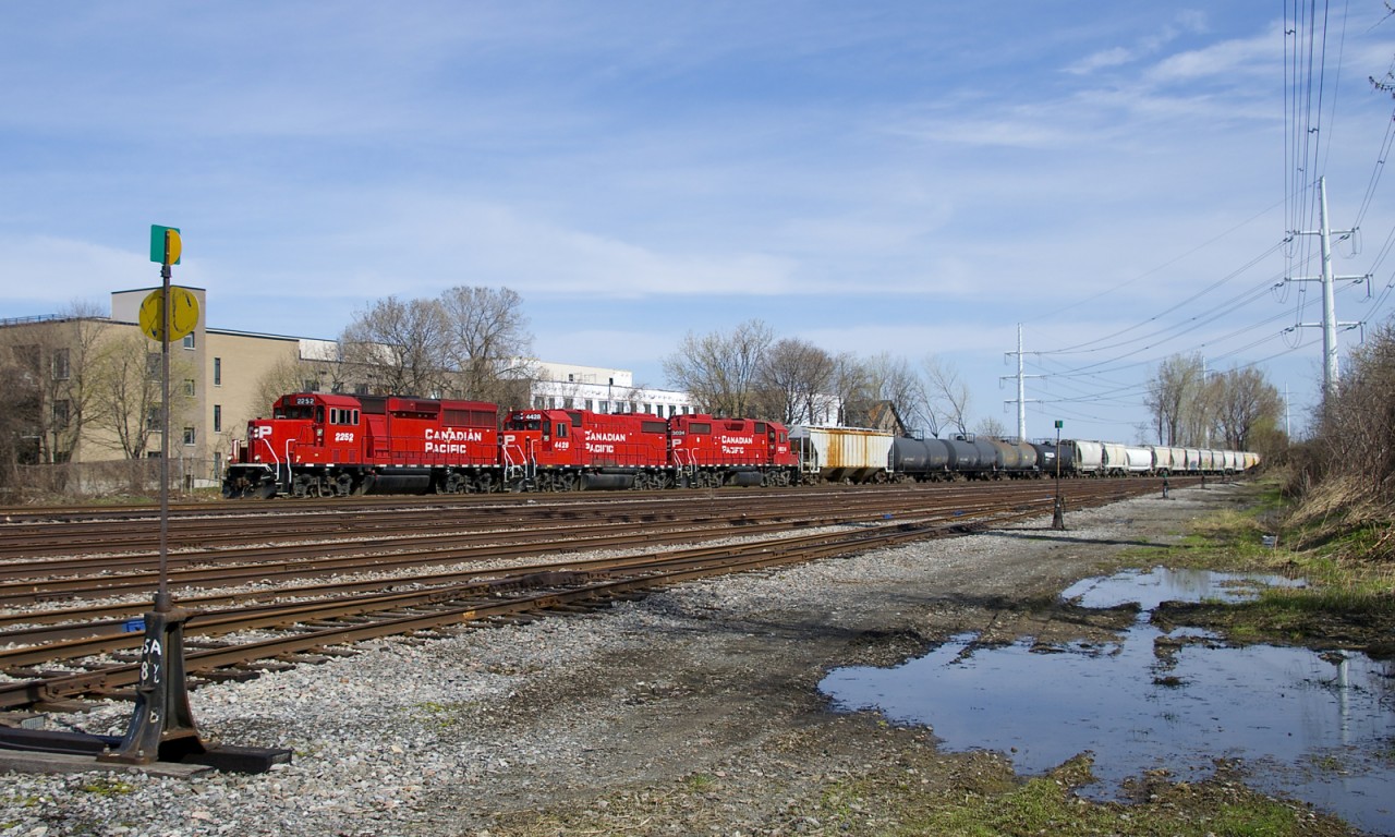 CP F94 with CP 2252, CP 4428 & CP 3024 is passing the north end of the Lasalle Yard with cars for clients on the Lacolle Sub.