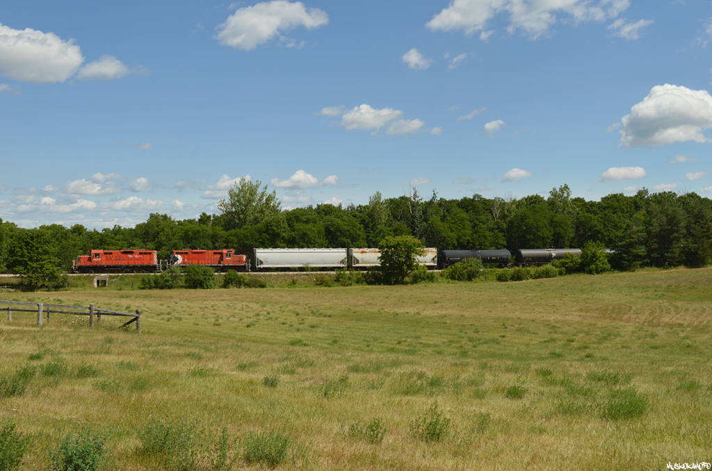 OSRX 8235 and OSRX 1591 (both former CP) trundle North towards Guelph with 11 cars plus former CP van OSRX 434462 in tow.