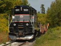 CCGX (BCRY) 1001 shoves 2 flats loaded with rail and an end of track bumper from the Molson spur out the South end of the Big Bay Point spur, shortly they'll hop on the former CN Midland sub engine first for the runaround at Innisville. 