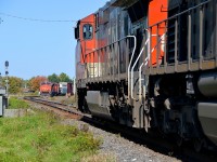 CN 401 with CN 2287 leading is in the hole at Saint-Léonard-d'Aston for CN 310, which is bound for Joffre Yard with CN 2641 leading. CN 401's crew is out to give a roll-by to the passing train.