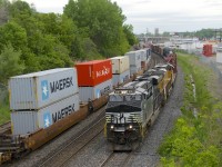 NS  8167 & UP 2555 lead a 58-car CN 529 past a stopped CN 149 at left. CN 149's power has gone into nearby Taschereau Yard to lift cars before continuing west.