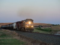 FPSK?.... It doesn't have the same ring to it.   UP 5521 is on the point of a westbound on CP's Wilkie sub just east of Biggar SK along side the CN siding named Neola. The time is 21:02. 