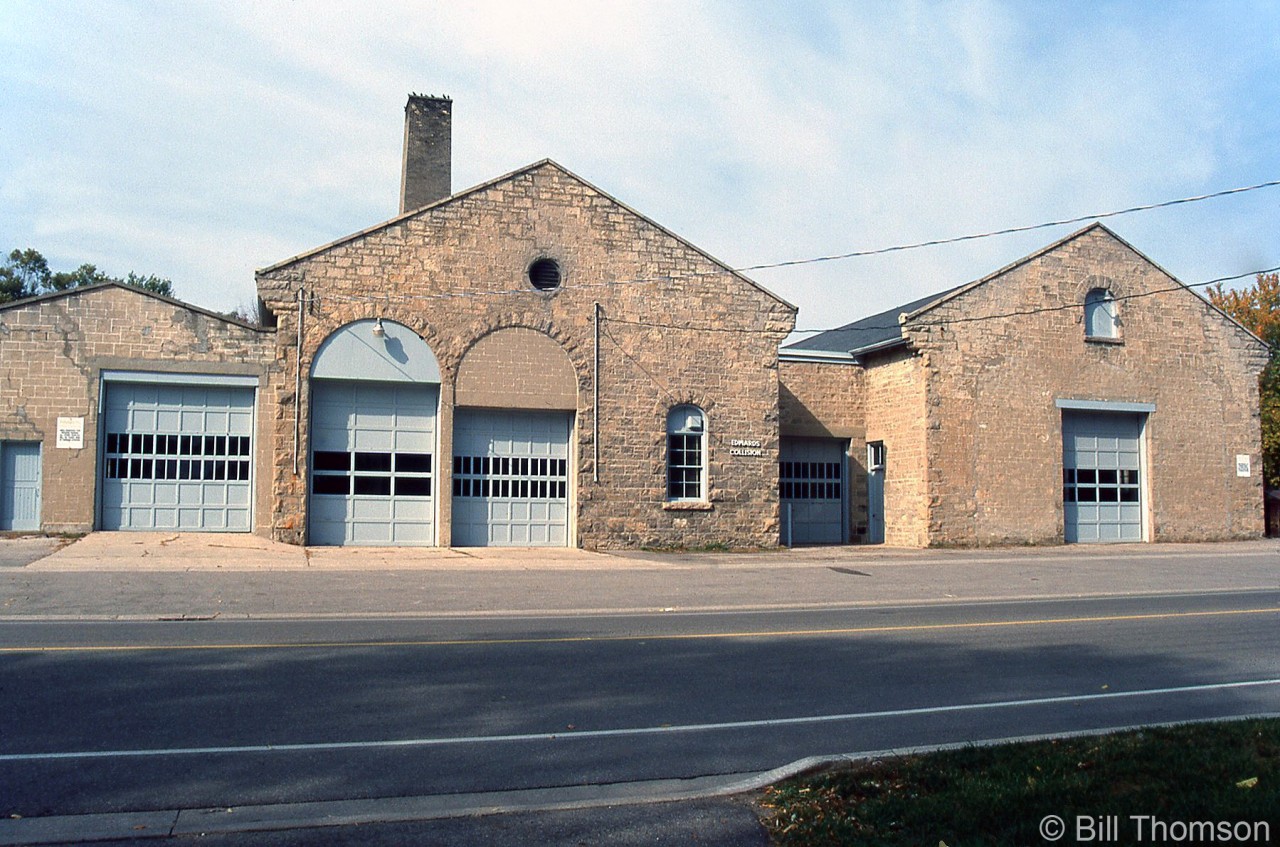 The former Guelph Railway Company streetcar barns at 371 Waterloo Ave. are pictured in October 1998. The building was built in 1895 by brewery owner John Sleeman to provide streetcar service for his employees. The city purchased the street railway in 1903, and the streetcars were eventually replaced by buses in 1937. The building was then used as a bus garage for the Guelph Transportation Commission until the 1970's, and saw use by various small businesses (used by Edwards Collision at the time of the photo). It was eventually converted to residential apartments by J. Lammer Developments Ltd., and is presently known as the "Greystone Residences" (more information here).