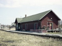 It is a shame most small towns have lost their charming railroad stations. Here is a view of the old CN station at Hastings, Ontario; back when I visited it was already left high and dry by the railroad, and was used for storage of various farm implements.
The railroad thru here began as the Grand Junction, opening around 1878 thru here. It was merged with the Midland Rwy in 1882 and leased to the Grand Trunk in 1884. GTR much later then was taken over by CNR. I do not have the date the station was demolished, but I do know the railroad alongside of it was taken up in early 1987.