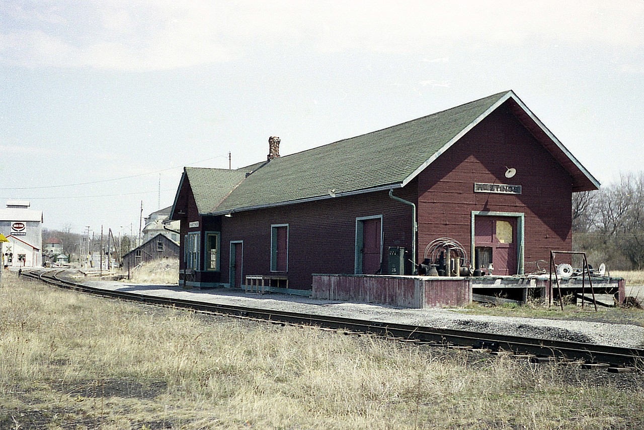 It is a shame most small towns have lost their charming railroad stations. Here is a view of the old CN station at Hastings, Ontario; back when I visited it was already left high and dry by the railroad, and was used for storage of various farm implements.
The railroad thru here began as the Grand Junction, opening around 1878 thru here. It was merged with the Midland Rwy in 1882 and leased to the Grand Trunk in 1884. GTR much later then was taken over by CNR. I do not have the date the station was demolished, but I do know the railroad alongside of it was taken up in early 1987.