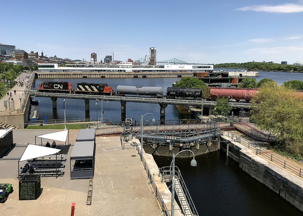 The Pointe St-Charles Switcher has CN 7726, CN 4135 and four cars to interchange to the Port of Montreal as it cools its heels, awaiting security to flag the crossings in this area.