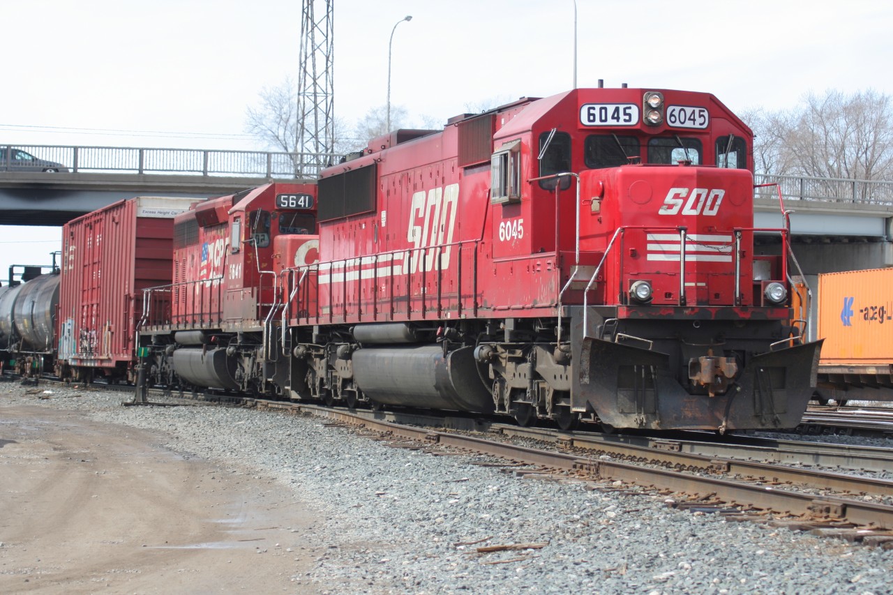 An eastbound Canadian Pacific train is switching the Quebec Street yard in London, Ontario with SOO Line SD60 6045 and CP SD40-2 5641.